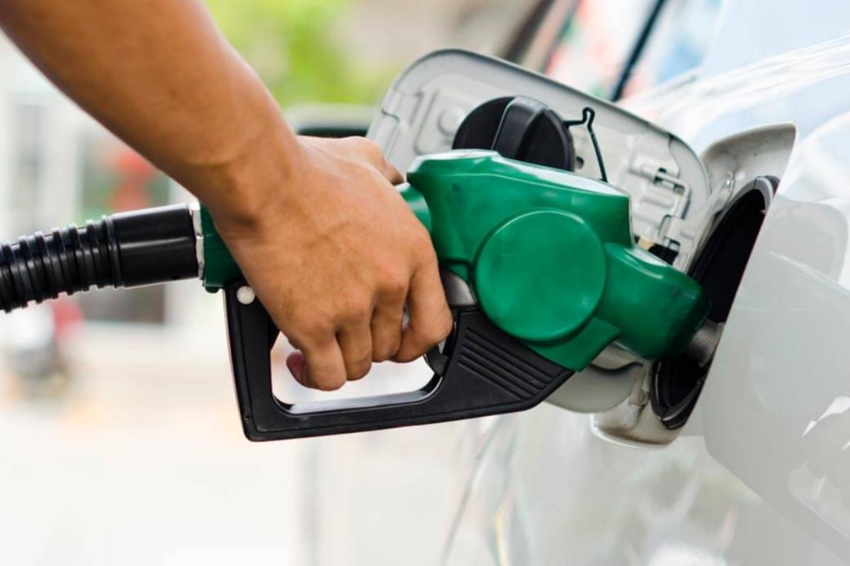 uomo che mette benzina in auto