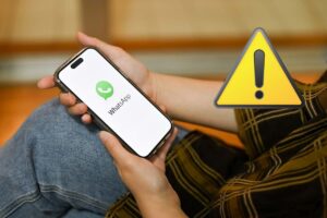 smartphone con whatsapp e segnale pericolo