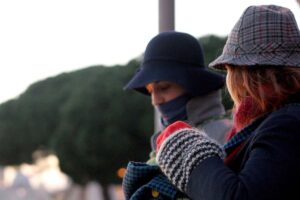 Due donne si riparano dal freddo indossando indumenti pesanti