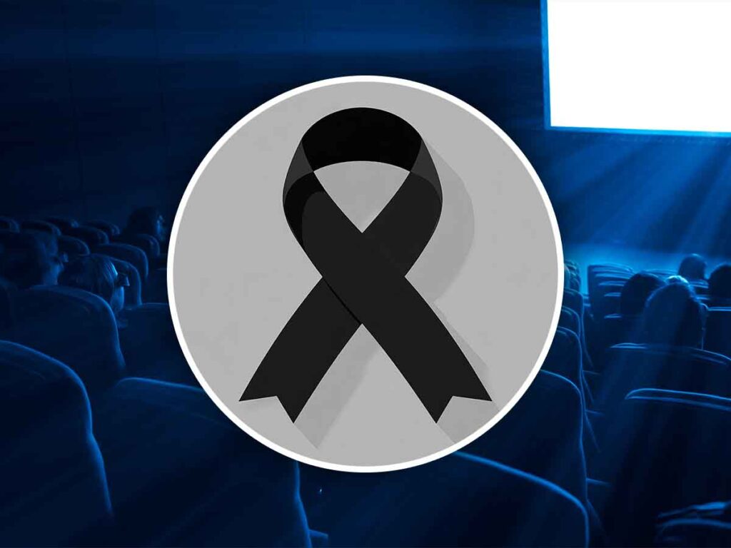 simbolo del lutto con dietro una sala cinema